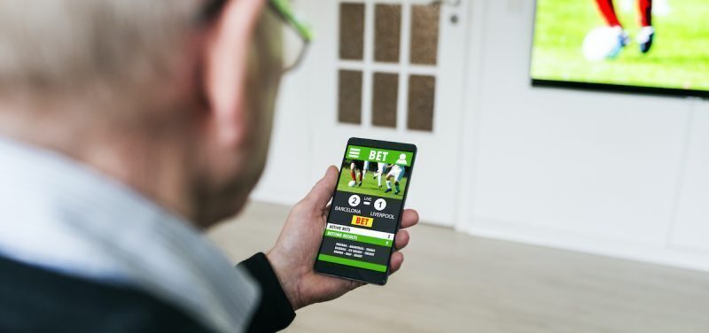 A man plots his sports betting strategy